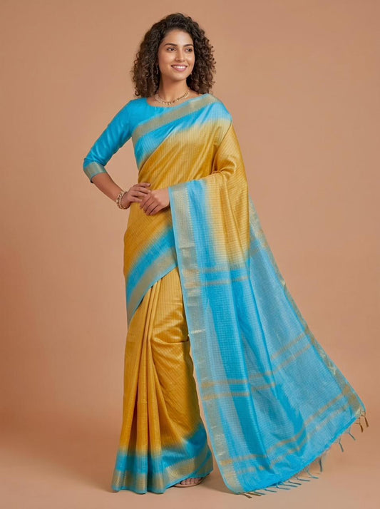 A woman modeling a yellow and blue gradient saree with a matching blue blouse against a solid beige studio background.
